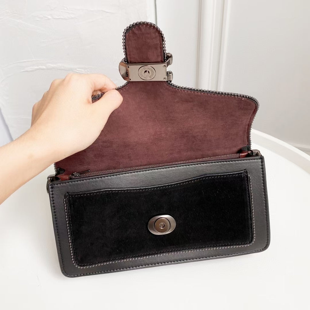 Coah bag with flap and snap closure, layered black and burgundy exterior