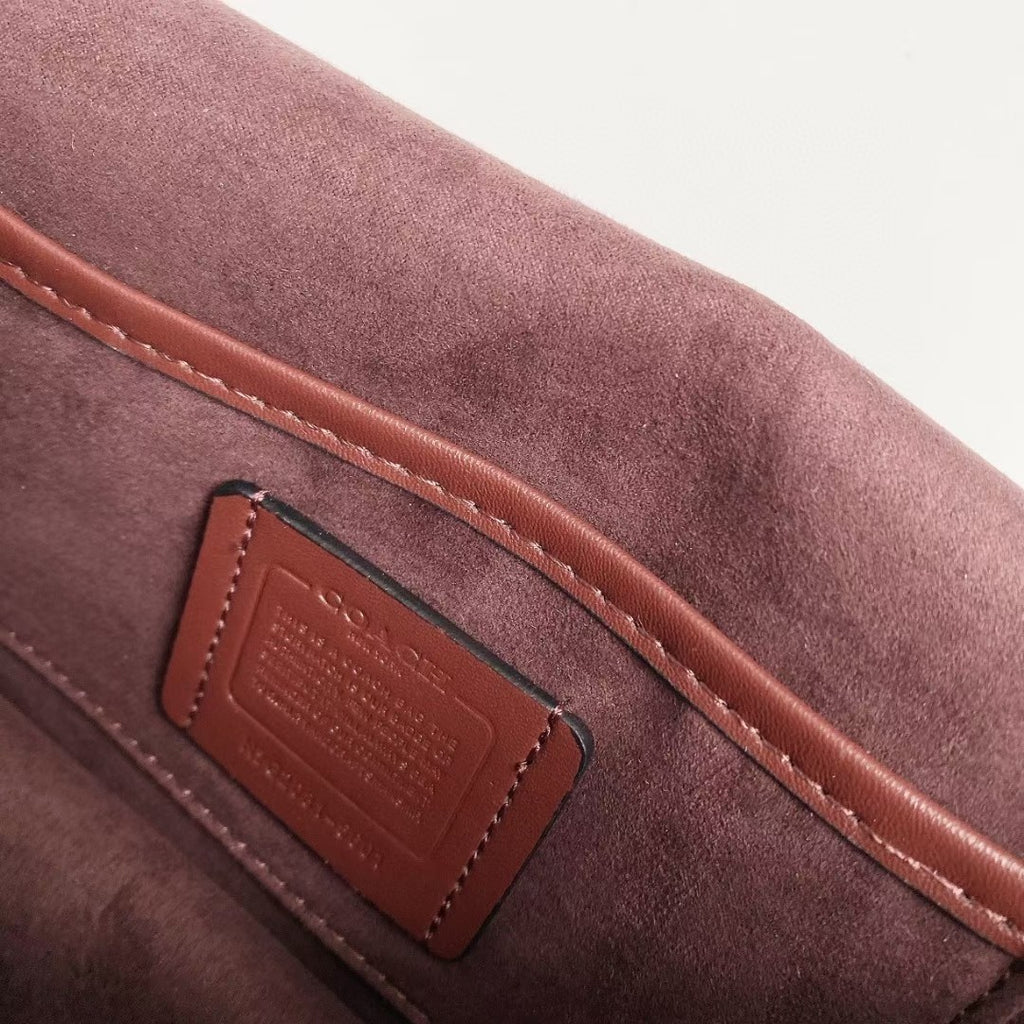 Coah bag leather patch detail with stitched trim, burgundy exterior