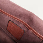 Coah bag leather patch detail with stitched trim, burgundy exterior