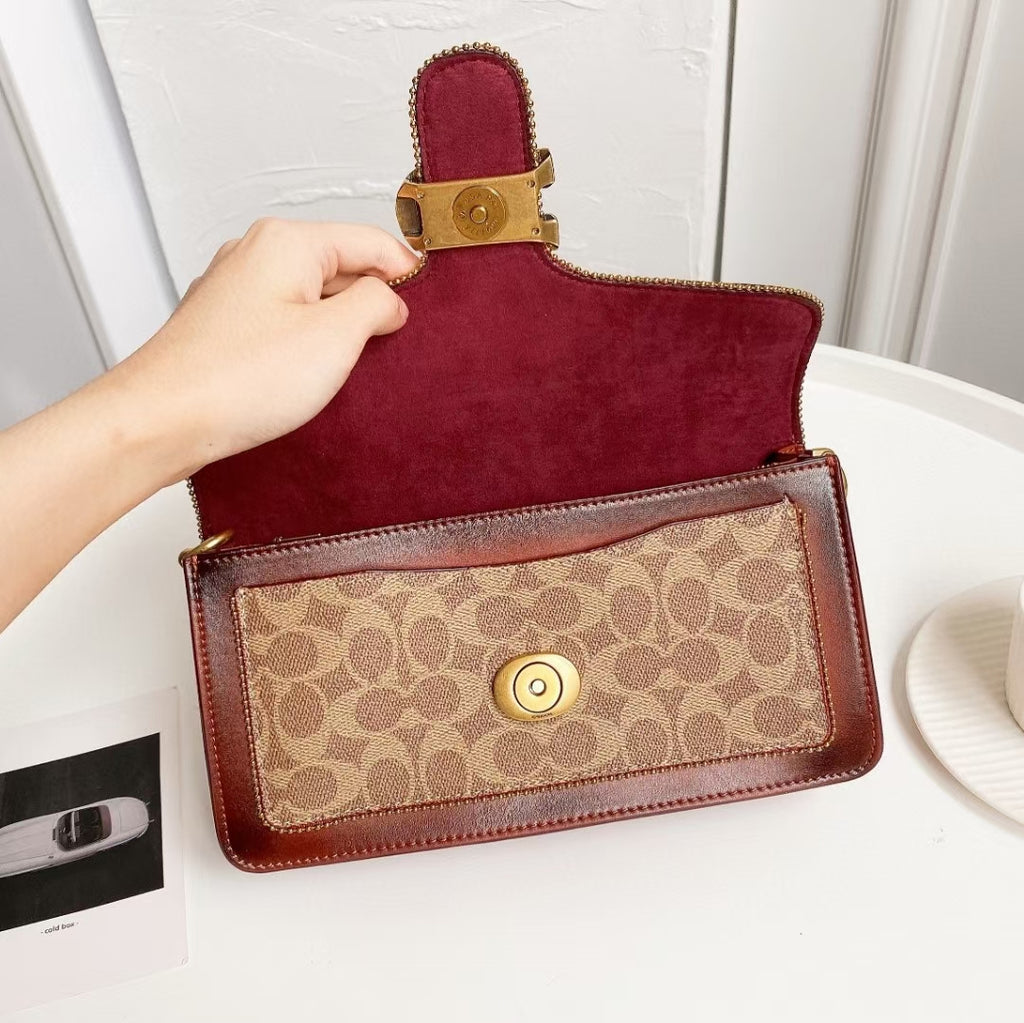 Coah bag with burgundy suede flap, tan logo front panel and gold center snap