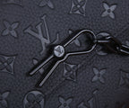 Louis Vuitton key holder clip with metal ring on dark monogram leather