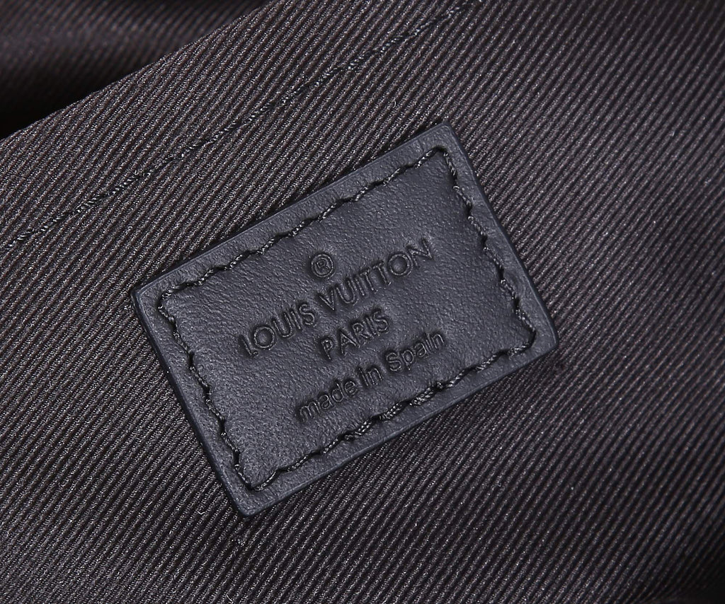 Dark fabric label on bag lining reading Louis Vuitton Paris and made in Spain