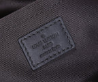 Louis Vuitton interior label, made in Spain, stitched on dark fabric