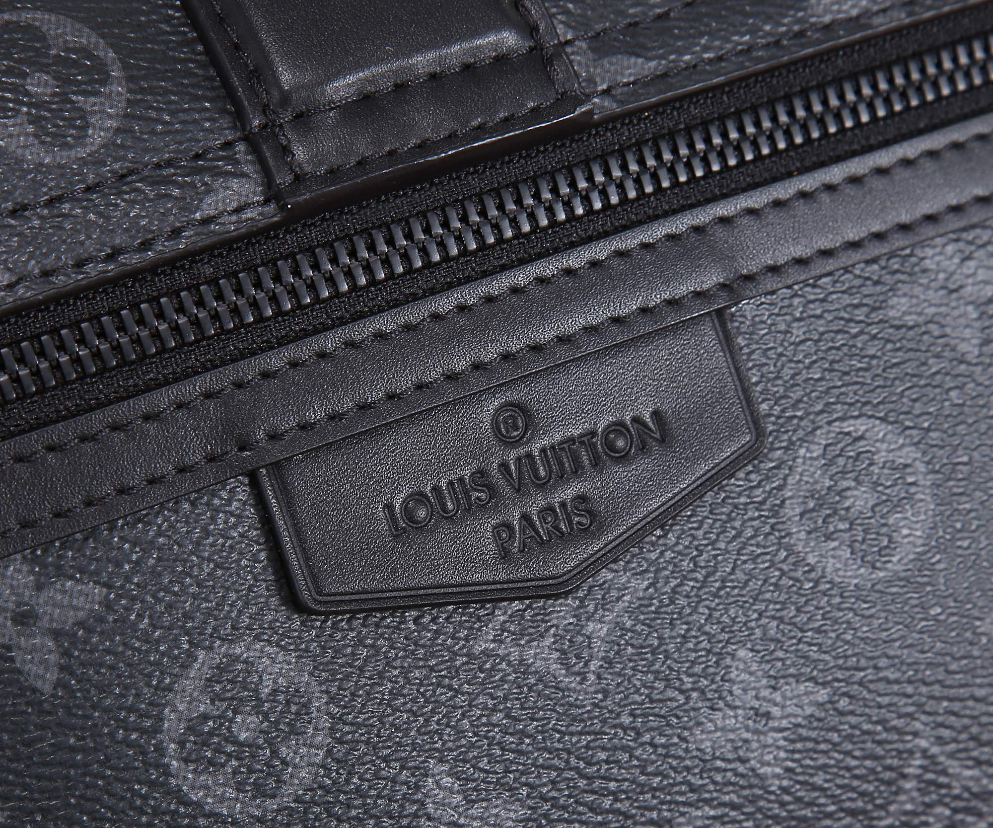 Louis Vuitton monogram bag embossed leather brand patch on zipper panel