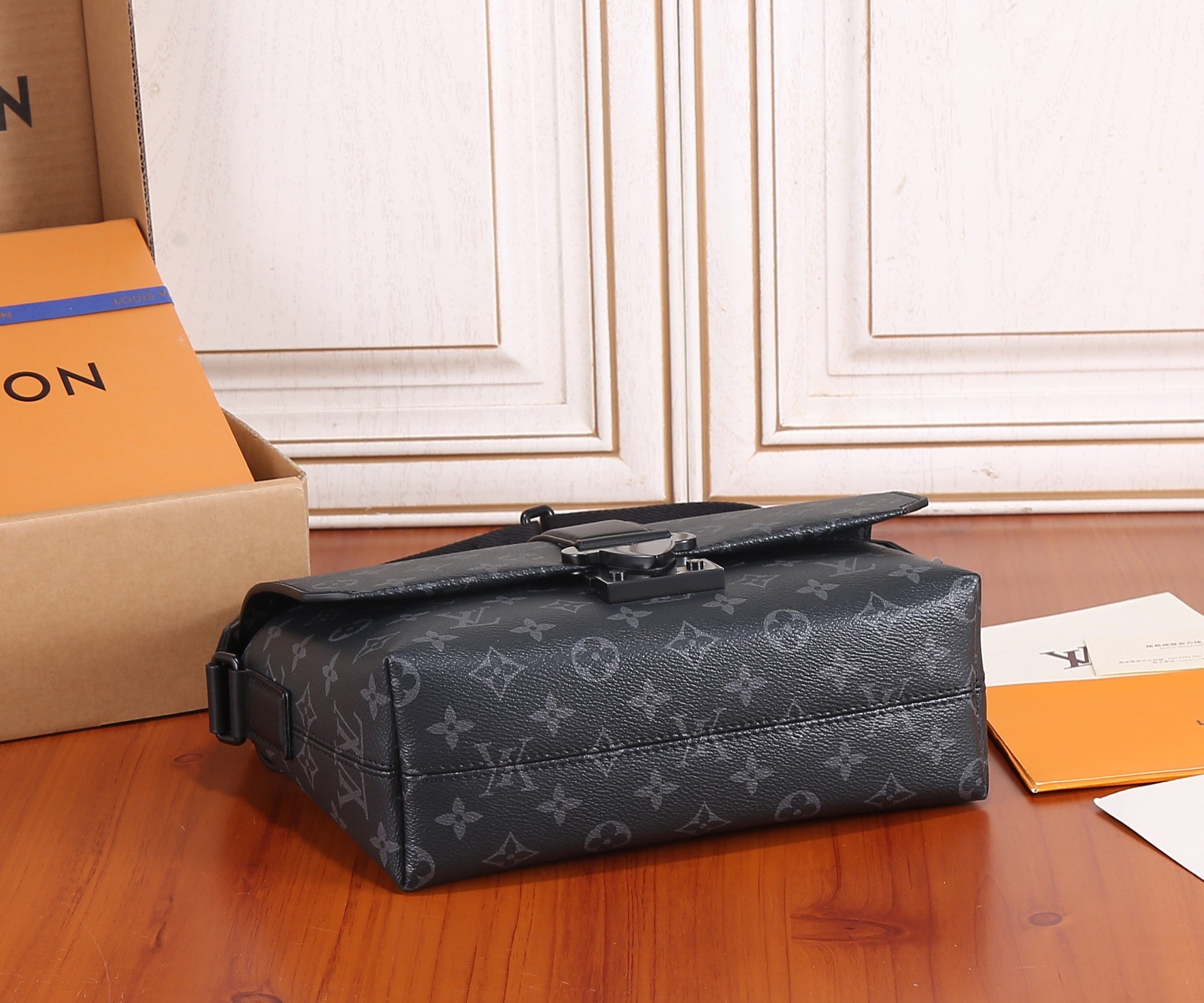 Men's Louis Vuitton monogram tote-style bag with top handle and crossbody strap