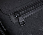 Dark monogram bag zipper pull with metal clasp and stitched leather trim