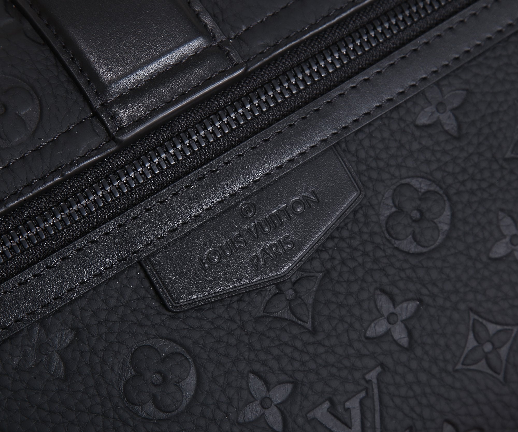 Dark monogram bag logo label and zipper track detail