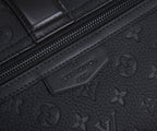 Louis Vuitton monogram bag close-up of embossed label on leather trim, dark