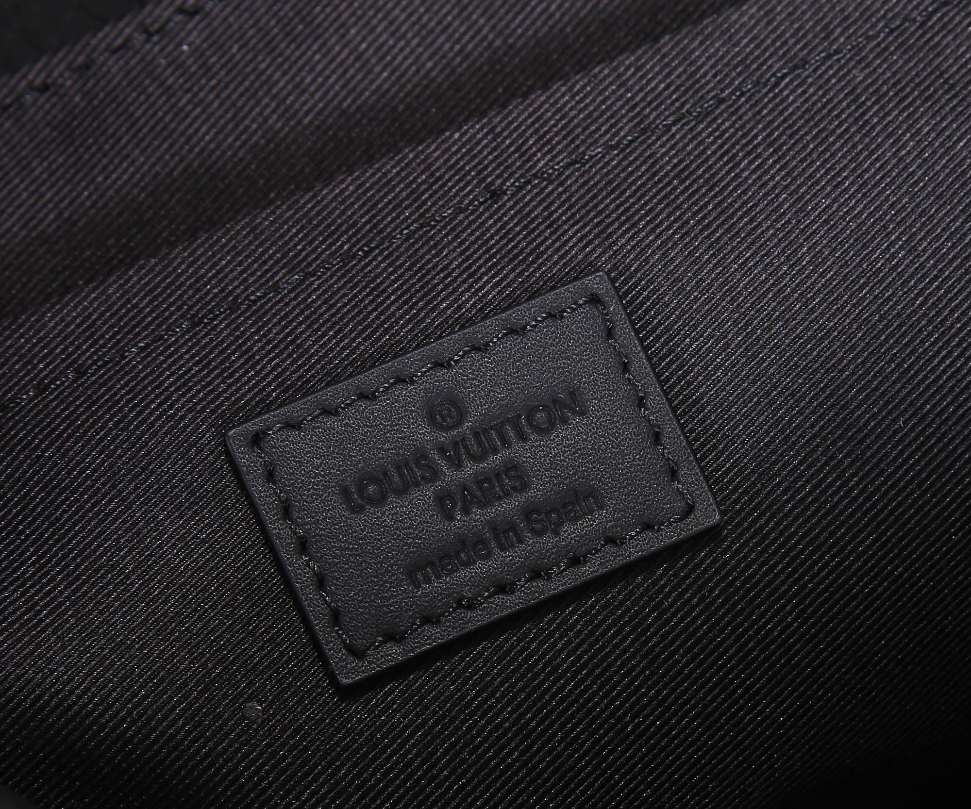 Dark monogram bag label patch with embossed text