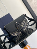 Dior mini bag with navy pebbled leather flap and blue-and-beige patterned canvas strap