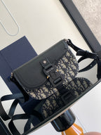 Dior mini bag with navy pebbled leather flap and blue-and-beige patterned canvas strap
