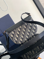 Dior mini bag with black pebbled leather base and blue-and-beige monogram canvas body