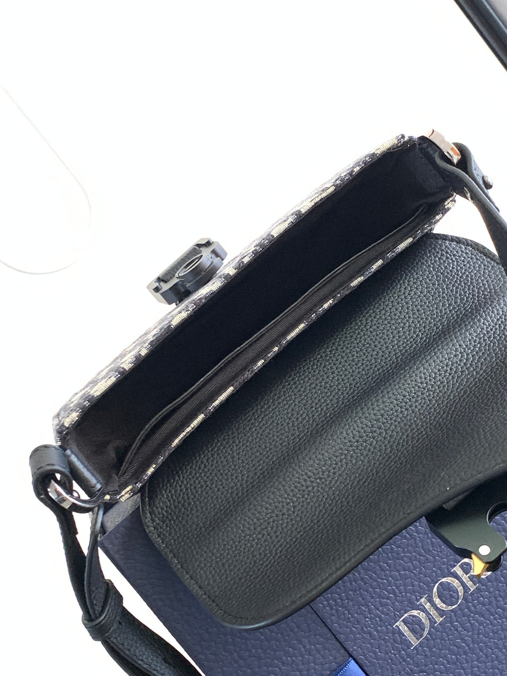 Dior mini bag with black pebbled leather side and zip-top opening with fabric lining