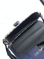Dior mini bag with black pebbled leather side and zip-top opening with fabric lining