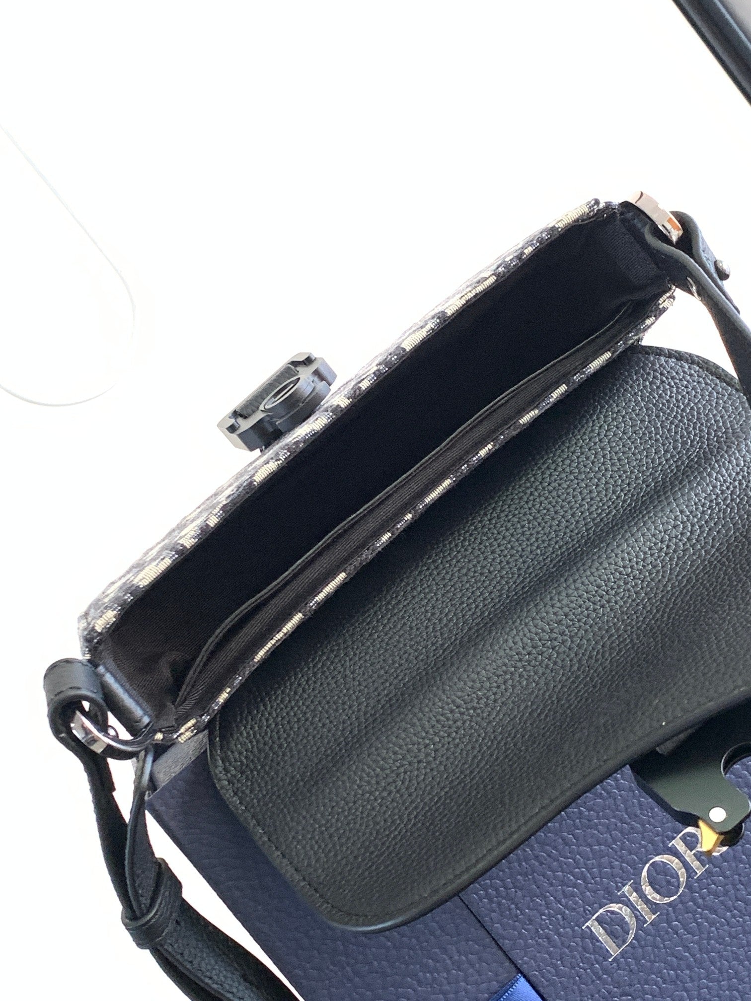 Dior mini bag with black pebbled leather side and zip-top opening with fabric lining