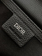 Dior leather patch with debossed 'Dior' logo on textured black grain