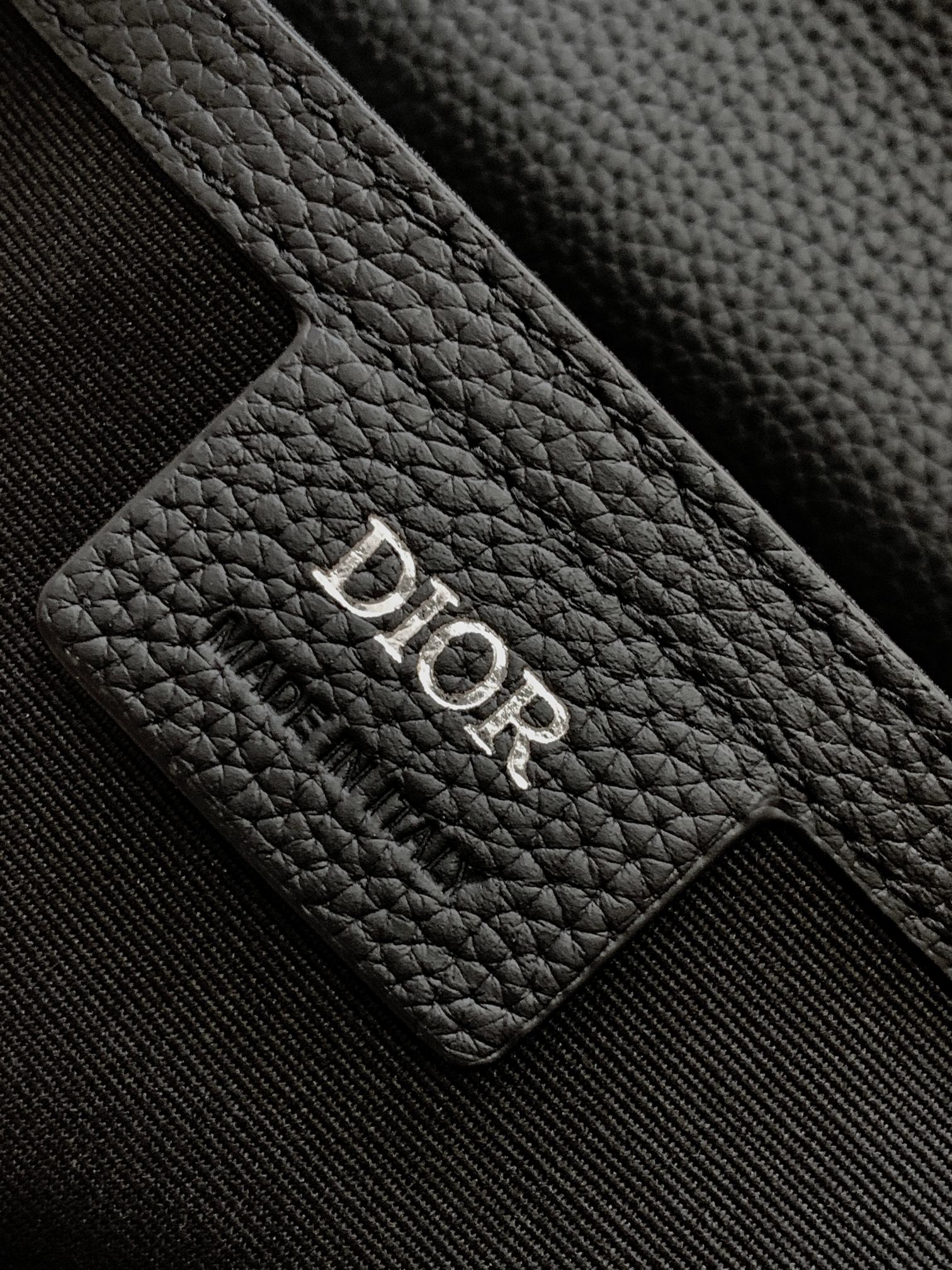 Dior leather patch with debossed 'Dior' logo on textured black grain