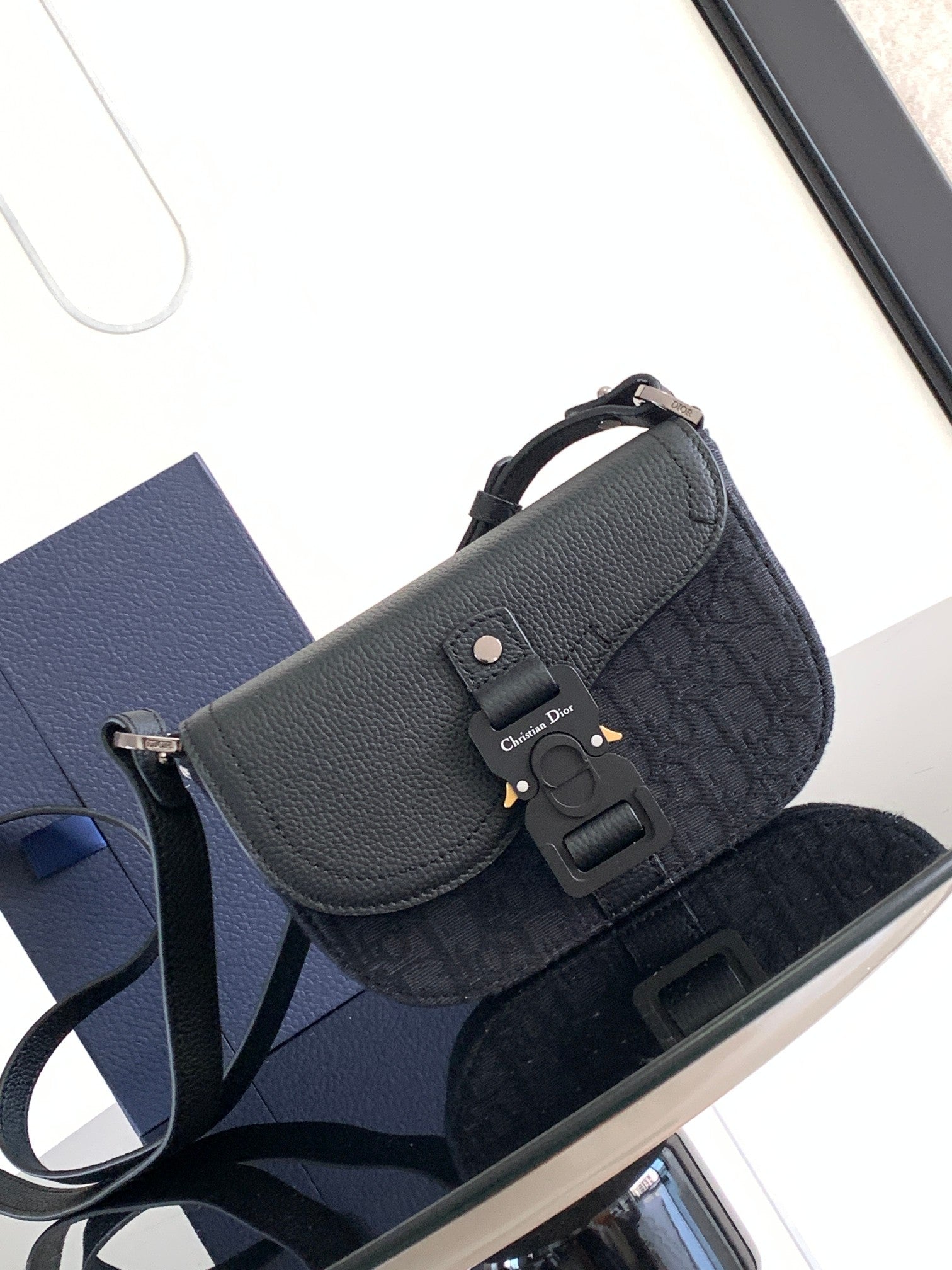 Dior flap shoulder bag, dark navy textured leather, adjustable strap, metal clasp