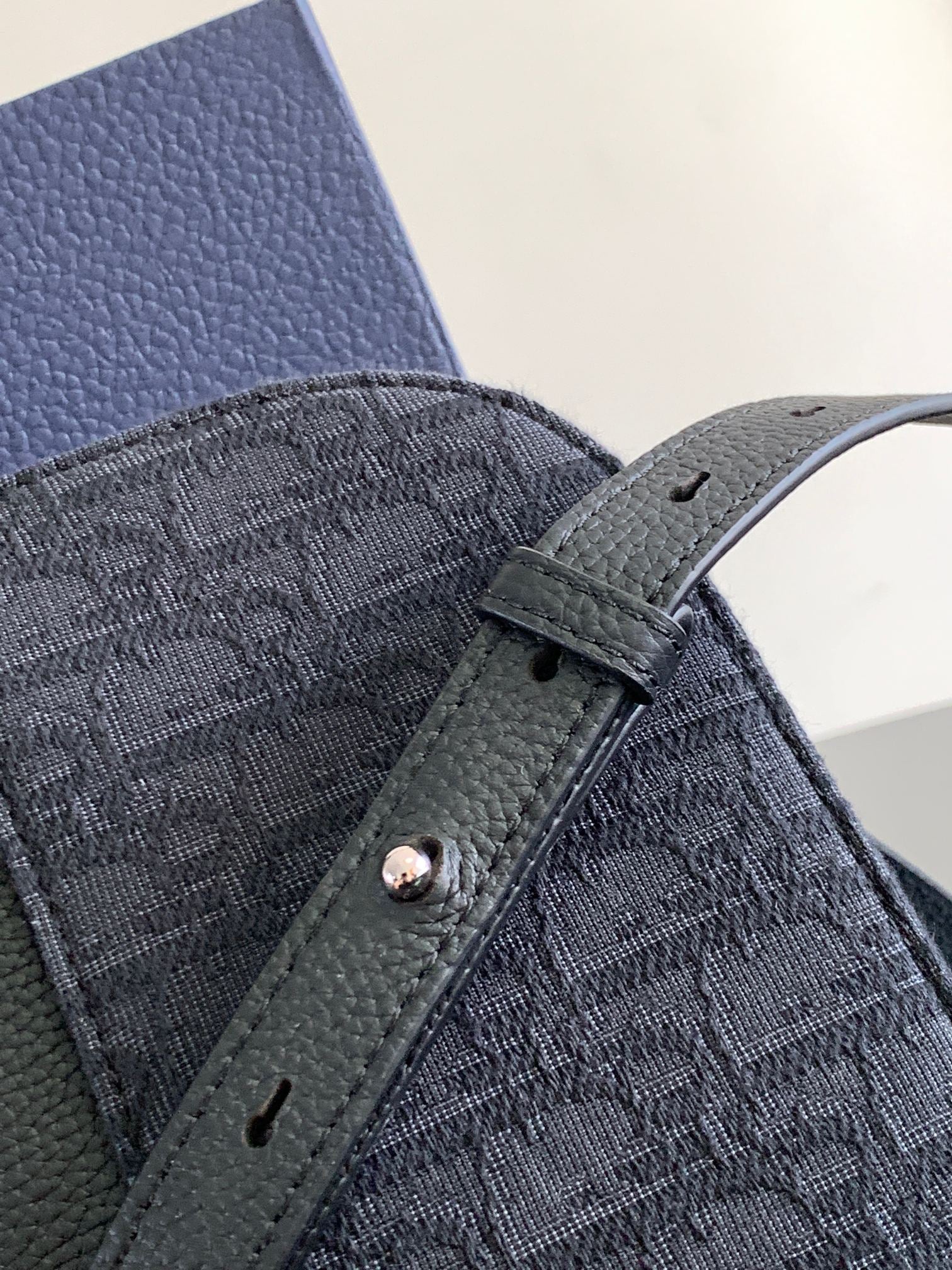 Dior bag front panel, dark textured fabric with snap tab and stitched trim
