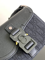 Dior small crossbody bag, dark pebbled leather with metal hardware and Dior charm