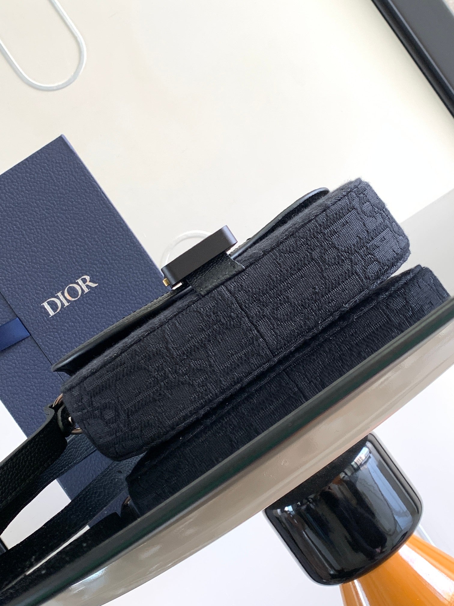 Dior crossbody bag with flap, dark monogram fabric, wide strap and top buckle