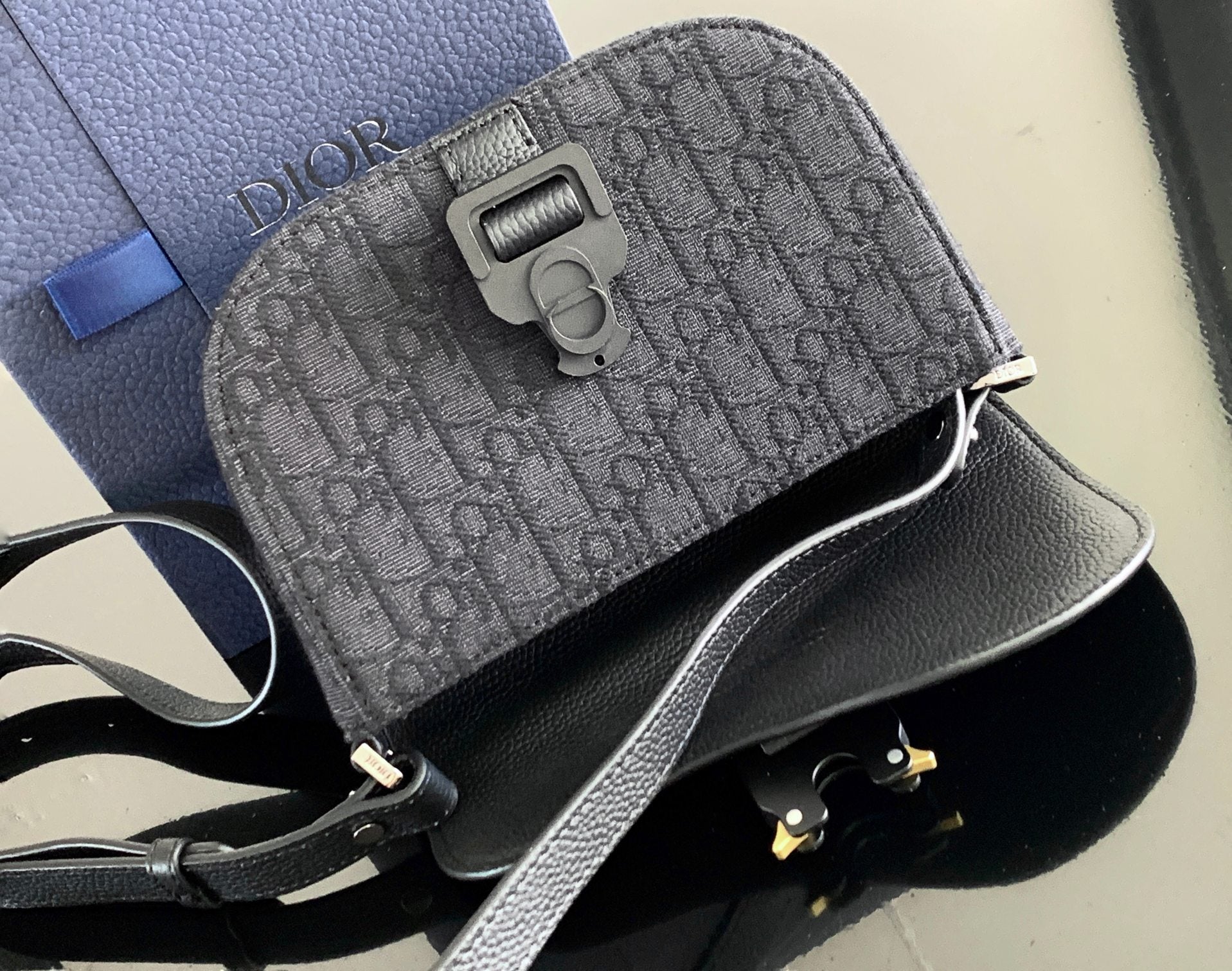 Dior mini crossbody bag, gray monogram canvas with buckle and Dior logo hardware