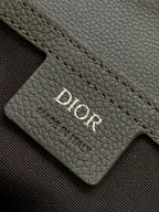 Dior gray leather card slot with Dior logo embossed on the panel.