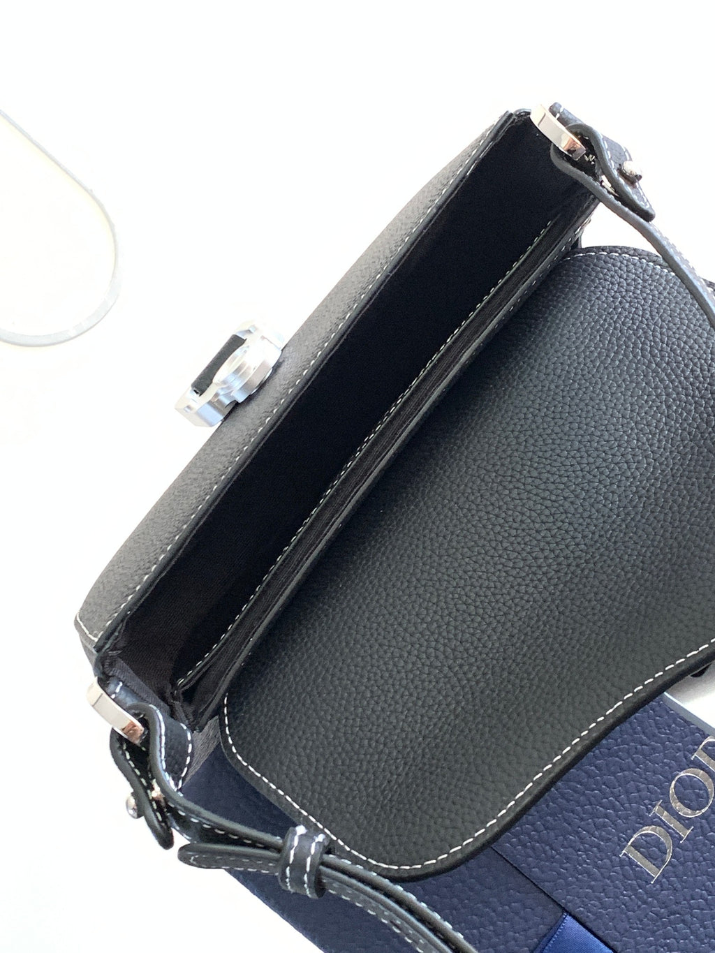 Navy leather Dior crossbody bag with open interior lining and edge stitching