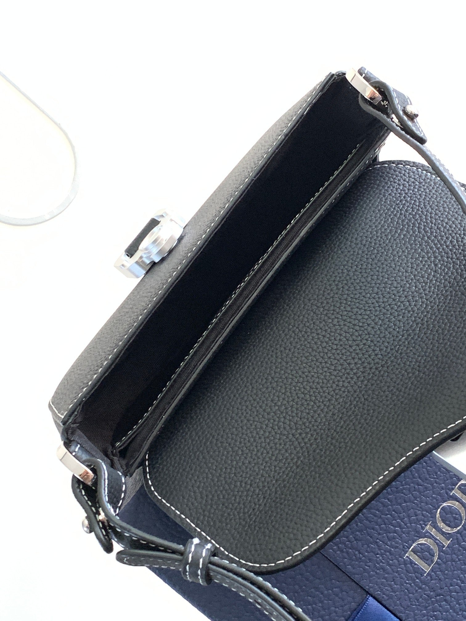 Navy leather Dior crossbody bag with open interior lining and edge stitching