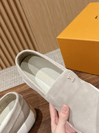 Louis Vuitton suede slip-on shoes, light beige, hand holding near box
