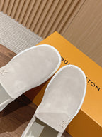 Louis Vuitton suede slip-on shoes, light beige, angled view on box