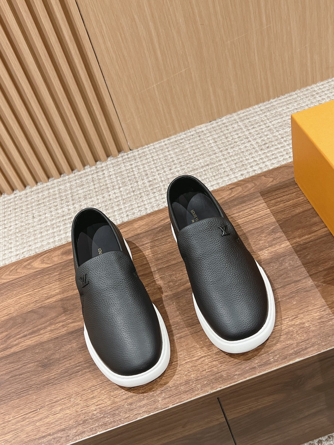 Black leather slip-on sneakers with white rubber sole