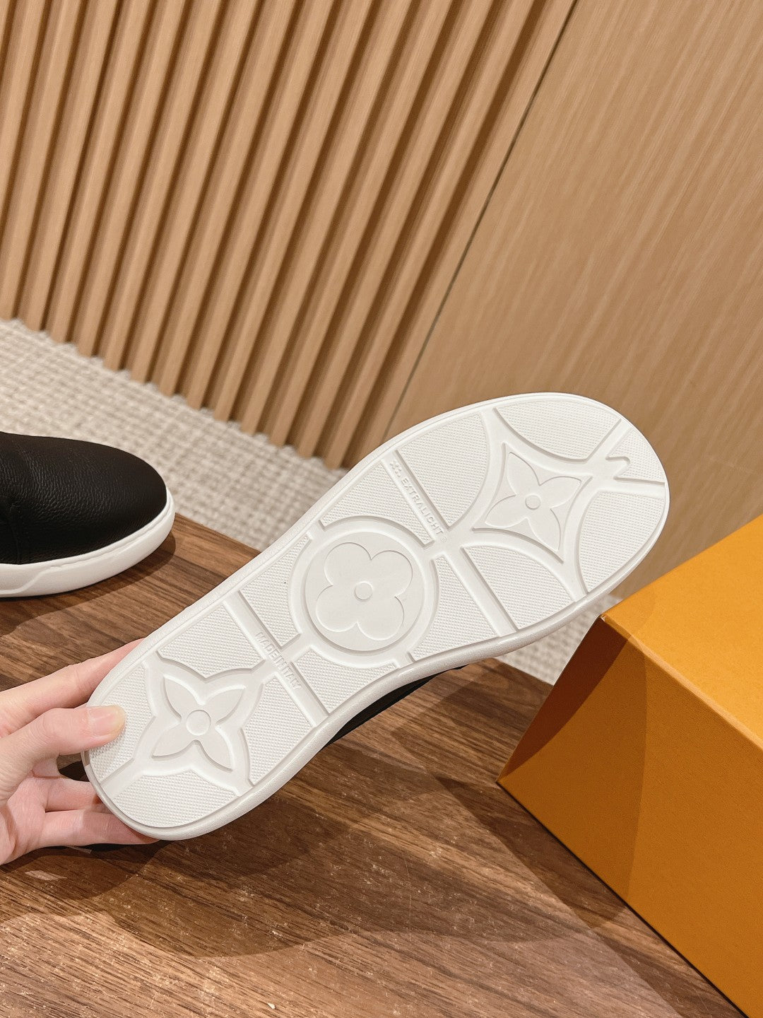 White patterned rubber outsole for black slip-on sneakers