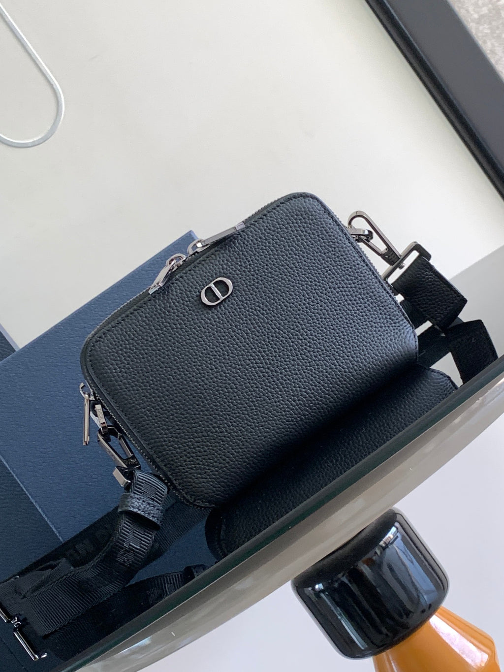 Small textured leather crossbody bag in dark blue with silver-tone hardware and D charm