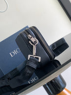 Crossbody bag with zip closure, textured dark blue leather, silver buckles and strap