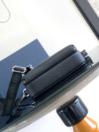 Slim zip crossbody bag in textured dark blue leather with wide strap and silver hardware