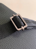 Textured dark blue leather strap attachment with silver buckle and loop hardware