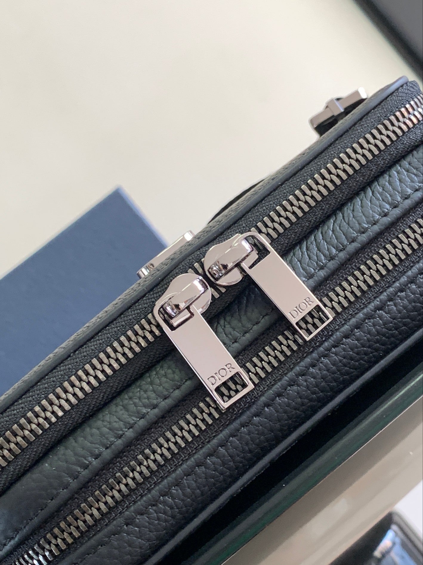 Dark blue textured leather crossbody bag with double zip and silver-tone Dior logo pull