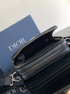 Double-compartment zip crossbody bag in textured dark blue leather with silver-tone hardware