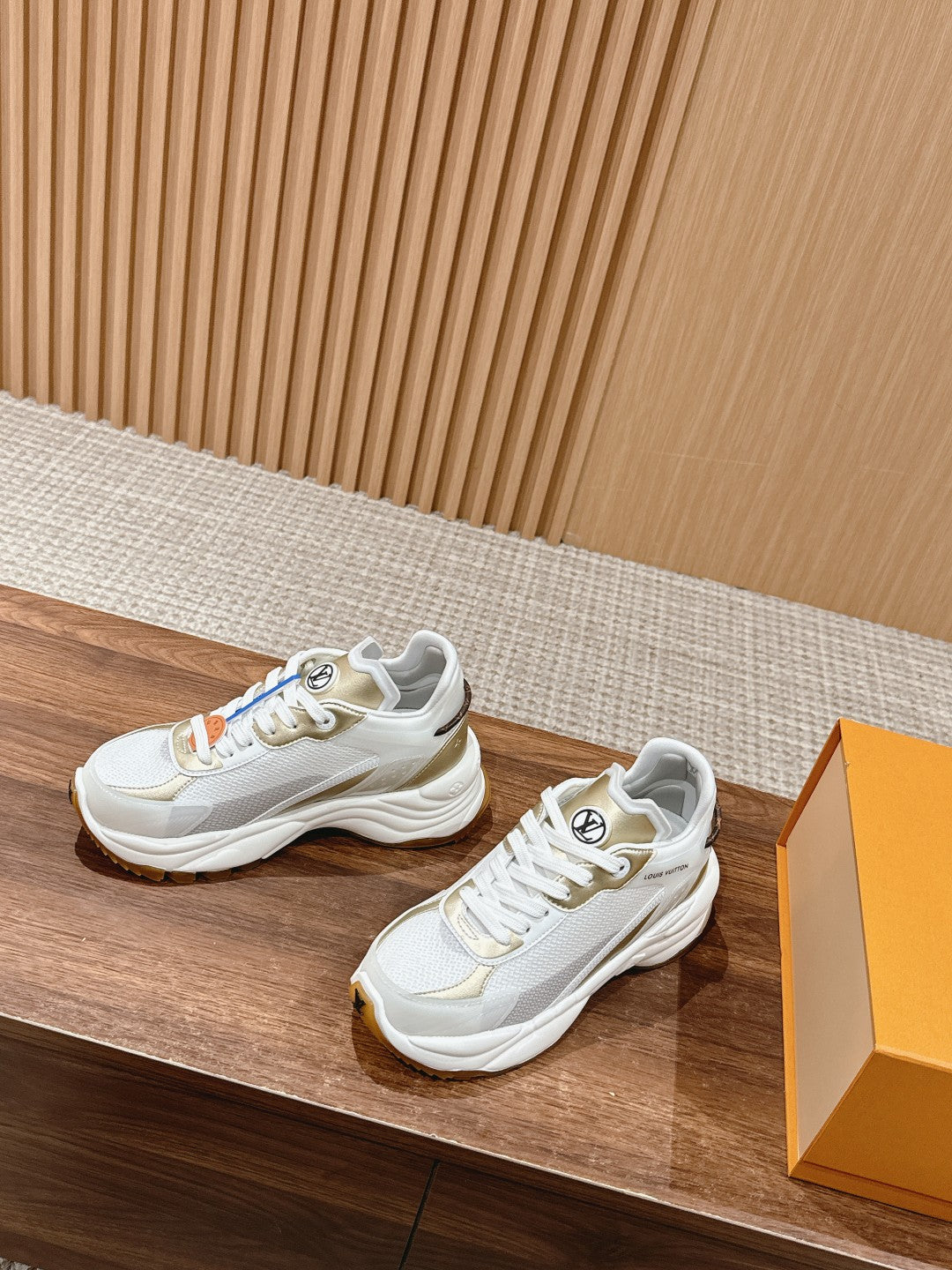 White Louis Vuitton unisex sneakers, side view with beige trim and lace-up