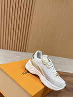 White Louis Vuitton unisex sneaker with gold logo accent and lace-up