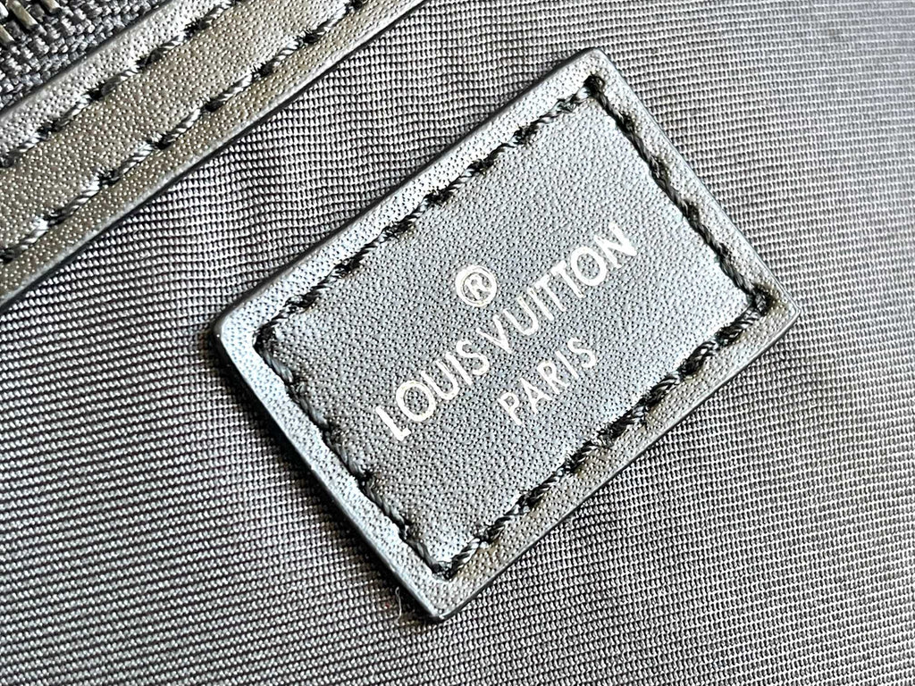 Louis Vuitton duffel bag leather logo patch with Louis Vuitton Paris text on textured panel