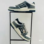 Amiri low-top sneakers, side view, dark blue and white with lace-up and logo patch