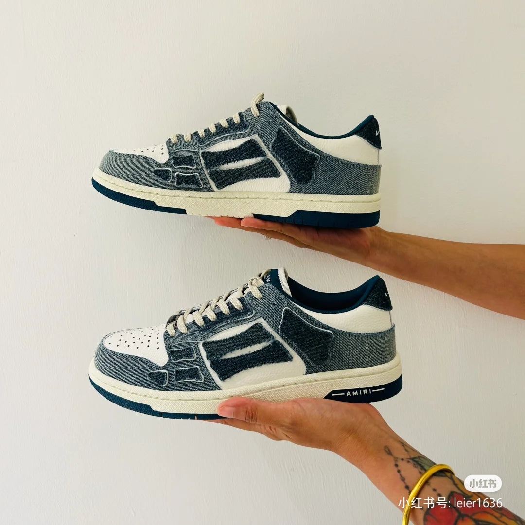 Amiri low-top sneakers held up, side profile, blue-gray suede with white accents