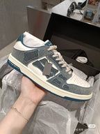 Amiri low-top sneakers in dark blue, white, and gray with lace-up and logo patch