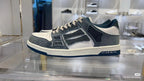Amiri low-top sneakers on display, dark blue-gray suede with white toe and side logo