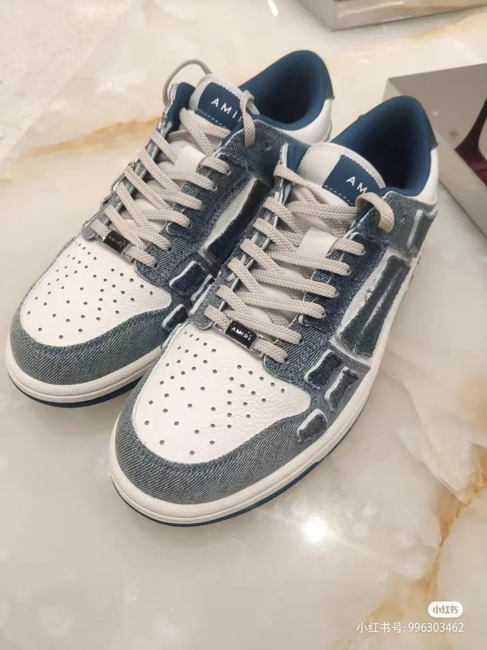 Amiri low-top sneakers pair, front view, dark gray-blue and white with lace-up