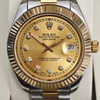 Rolex Day-Date watch dial with gold face, diamond markers, and date window at 3