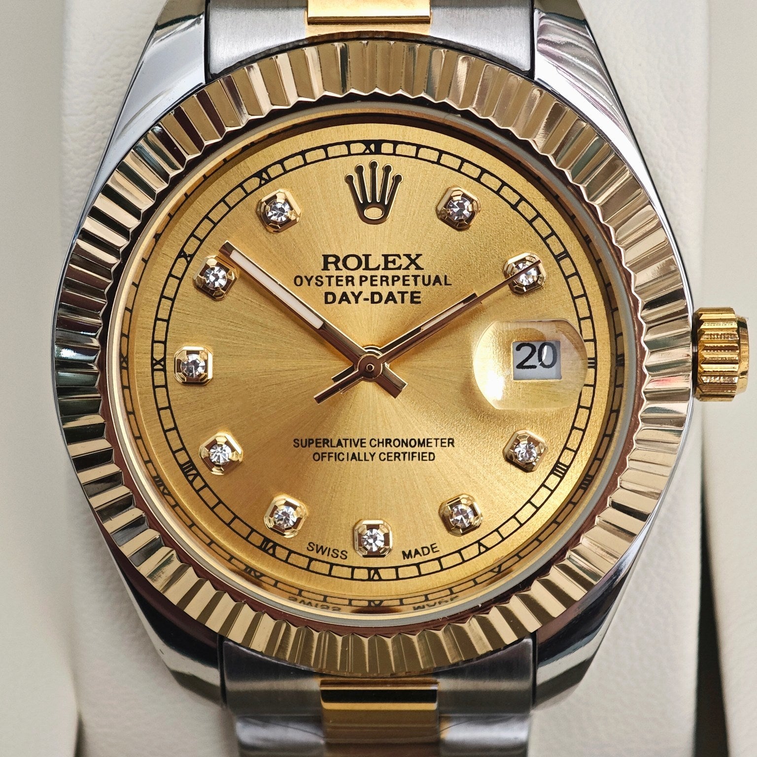 Rolex Day-Date watch dial with gold face, diamond markers, and date window at 3