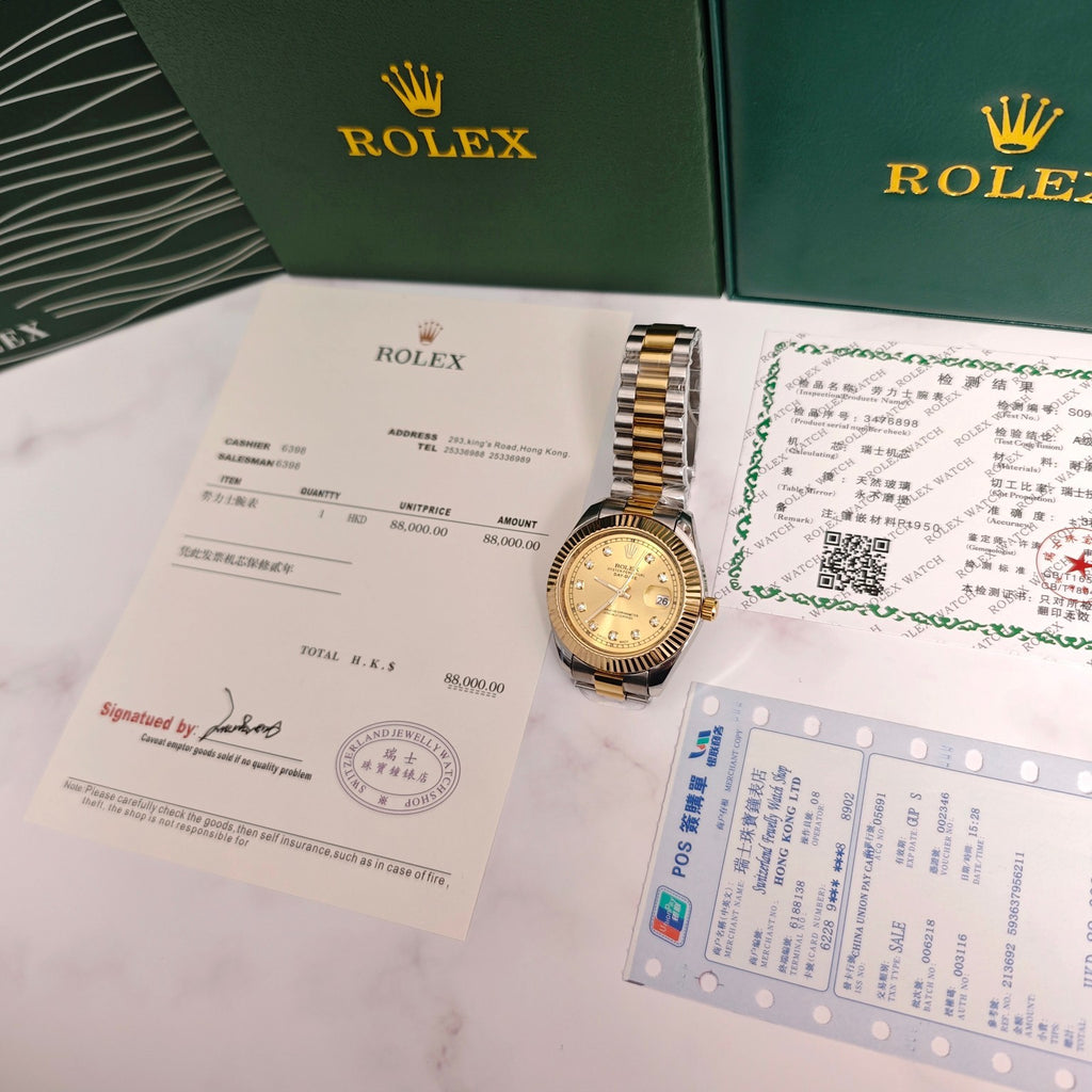 Rolex Day-Date watch with gold dial on paperwork and certificate in green presentation box